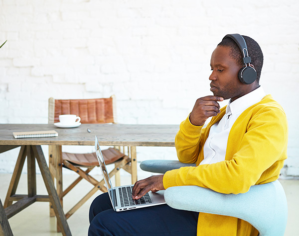 Man in headphones on laptop