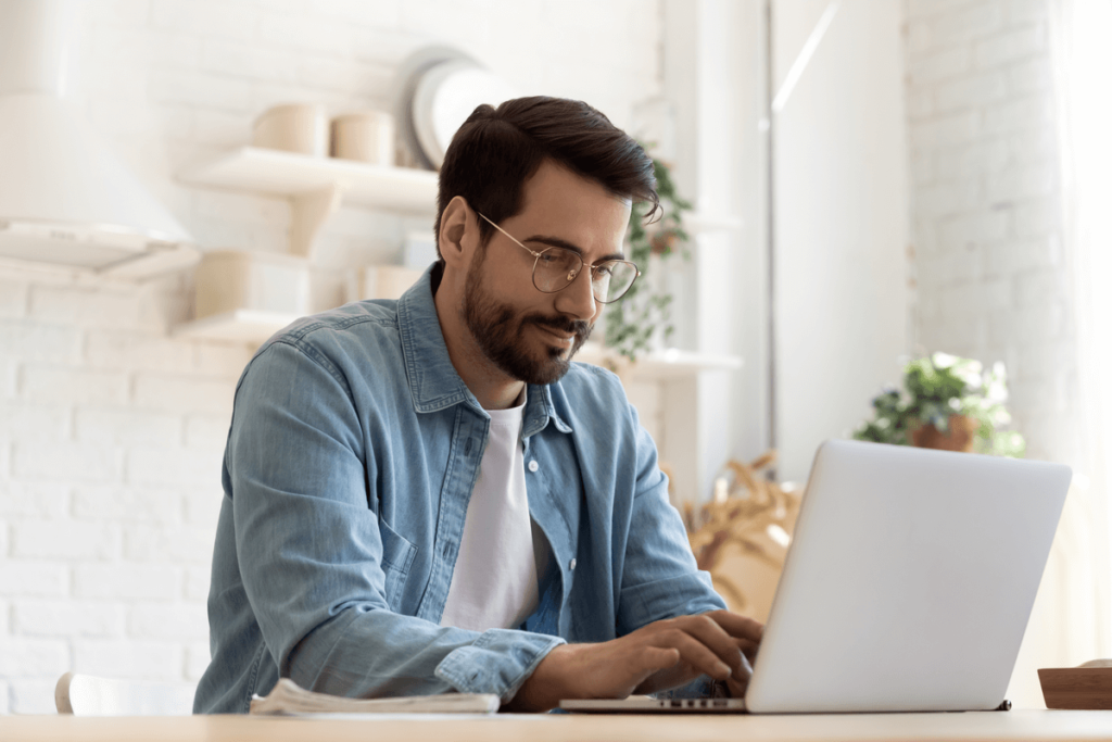 man typing on computer